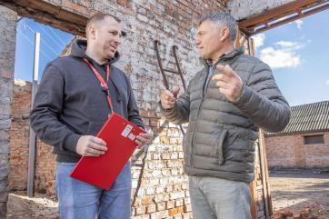 At his grain processing factory in ukraine, yurii (right) speaks with mykhailo (left), senior agricultural manager for mercy corps.