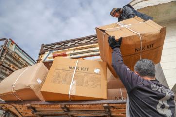 People carrying shipments of emergency supplies.
