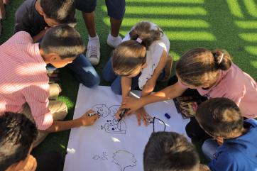 Palestinian children collaborating on an art project.