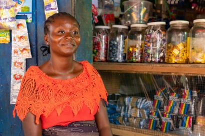 A person sitting in their dry-goods shop.