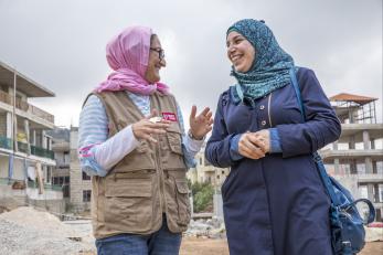 Mercy corps team member yasmin and alyamama looking at each other and smiling