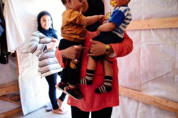 A mother holds two small boys in lebanon