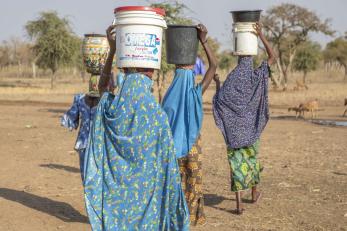 Women carry water from a nearby water point in kodomun-upper, built with support from mercy corps.