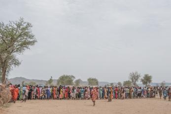 Line for food aid registration at a displaced peoples camp.