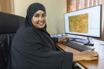A land surveyor and the primary digital mapping expert for wajir county sits before her computer.