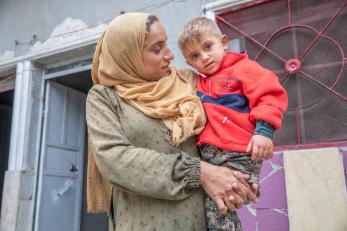 A woman in syria holds her child