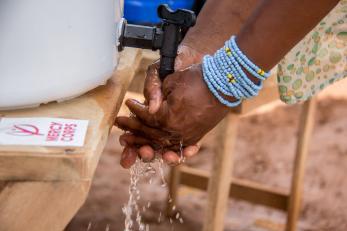Image: close-up of hand washing at a hand washing station