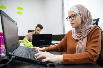 A person uses a computer in a digital learning platform in jordan.