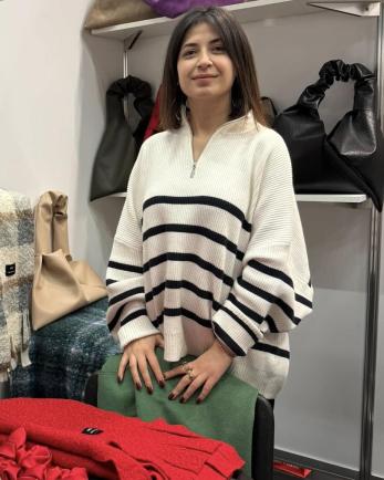 Georgian woman, founder of a company, stands am