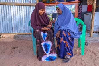 Two adults using a mobile phone.