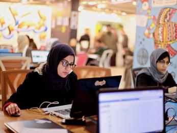 Woman operating a computer.