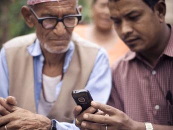 Two men looking at a mobile device