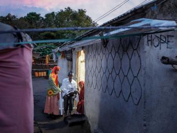 A family sitting outside their home.